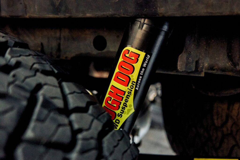 Close-up of a Tough Dog shock absorber fitted next to the rear wheel of a 4x4