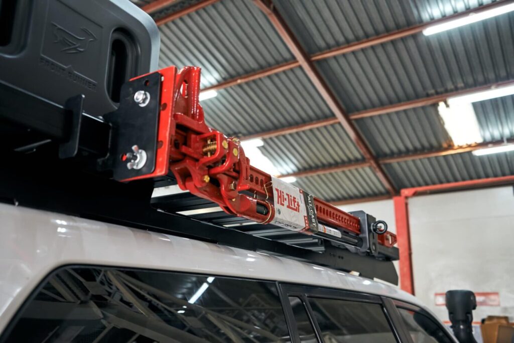 Hi-Lift jack and jerry can mounted on a roof rack in the Hi-Range workshop
