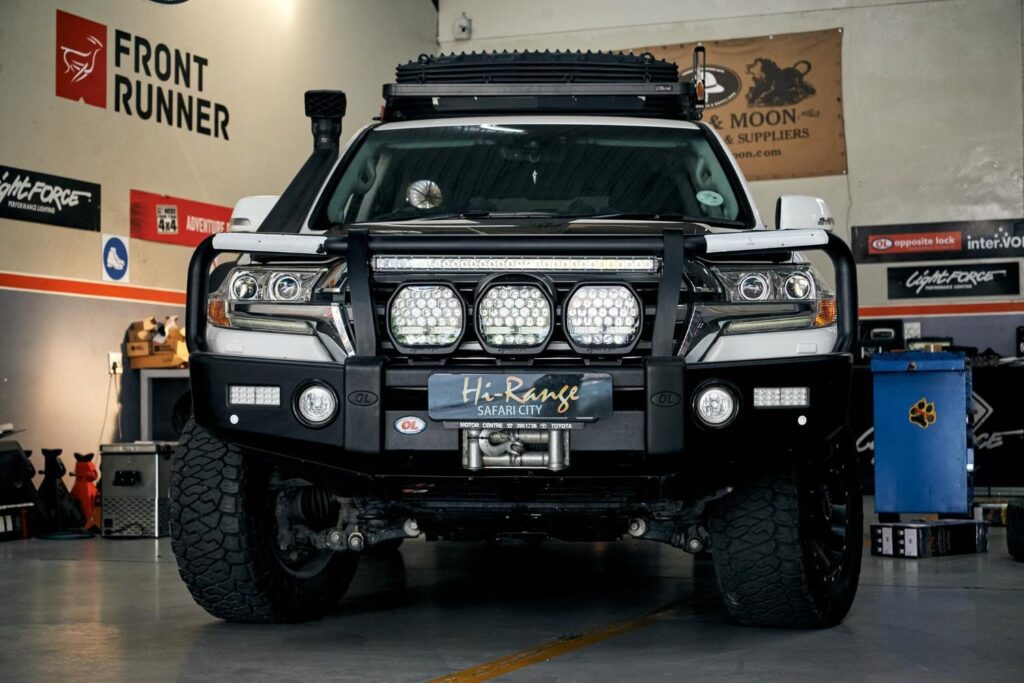 Front view of a 4x4 fitted with a Hi-Range branded bullbar, roof-mounted light bar and spotlights